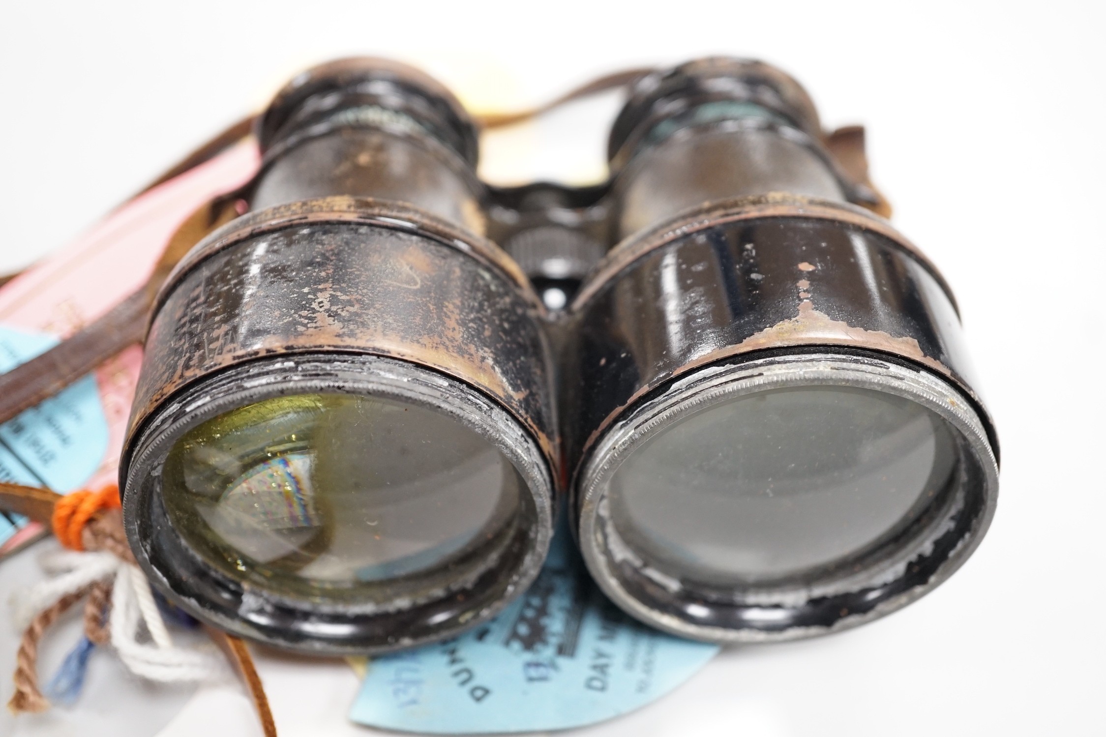 A pair of French binoculars in case, with various race meeting badges